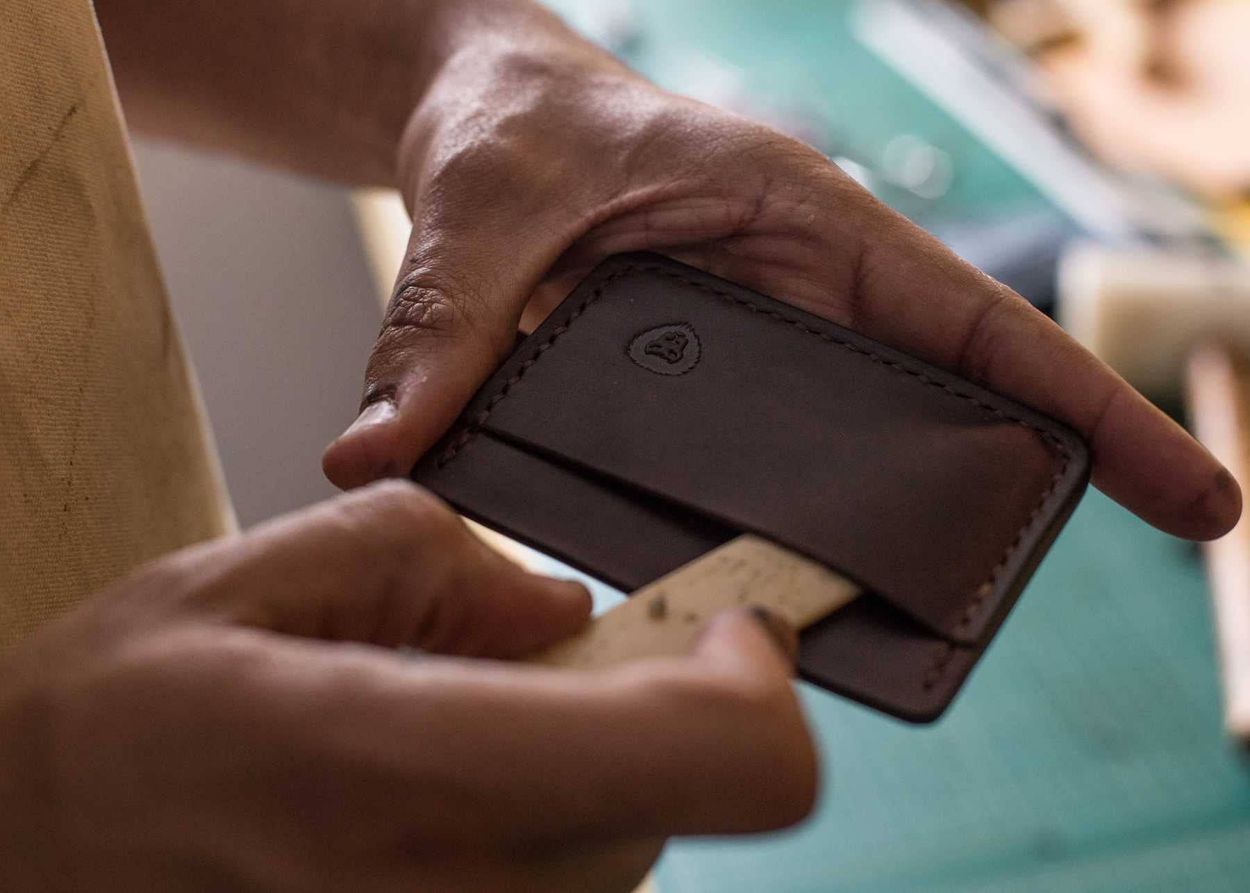 Kingsley crafting a dark brown leather cardholder